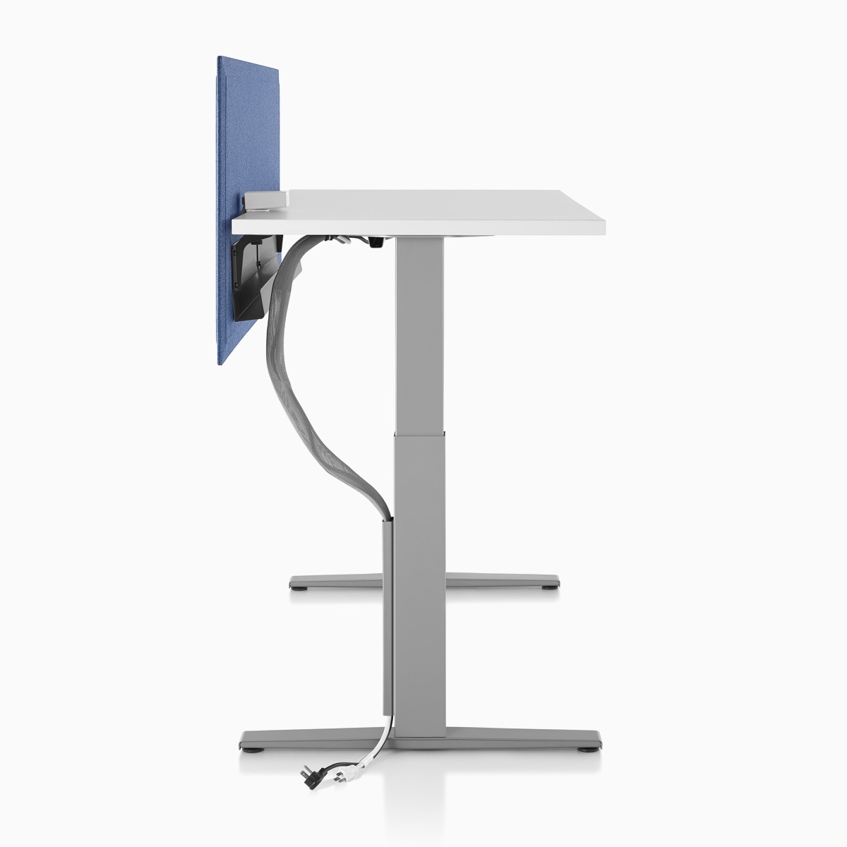 Side profile of Motia Sit-to-Stand Table with a cable management tray attached to the privacy screen and a cable manager attached along the base.