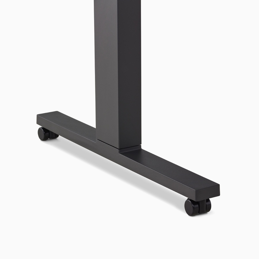 Close-up of a black Motia Sit-To-Stand Table leg with black casters.