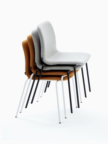 Stack of upholstered Viv Side Chairs with black and white 4-leg bases.