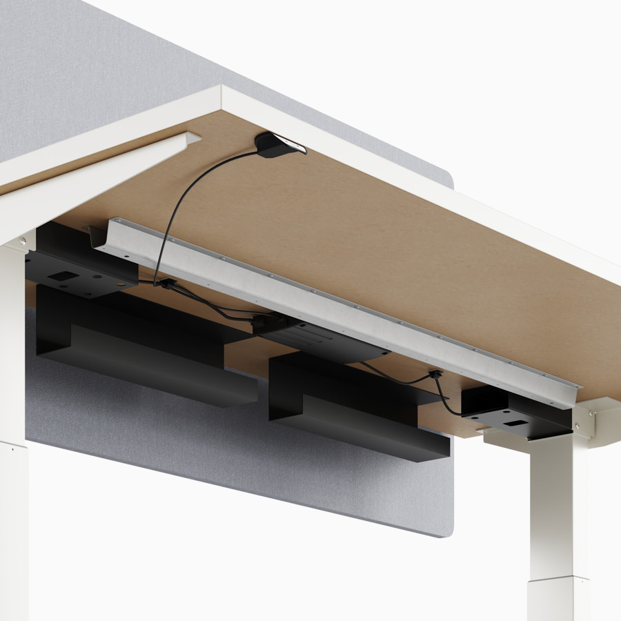 A close-up view of Nevi standing desk's under-surface cable trough.