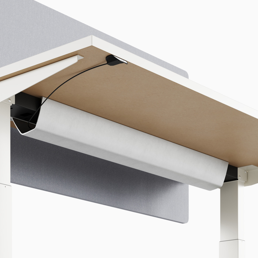 A close-up view of Nevi standing desk's under-surface cable tray.
