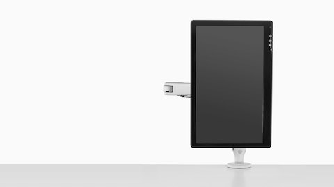 Front view of a monitor suspended in portrait orientation by a single light gray Ollin Monitor Arm.