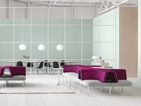 A Public Office Landscape setting featuring configurations of magenta and gray social chairs to support interaction.