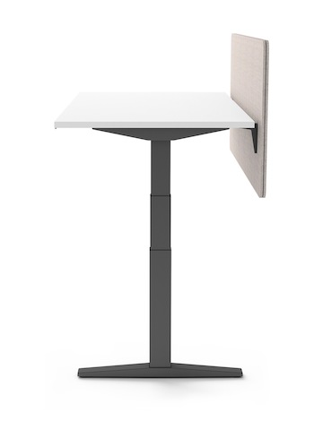 End view of single Ratio height adjustable desk with graphite understructue, white work surface, and frameless beige privacy screen.
