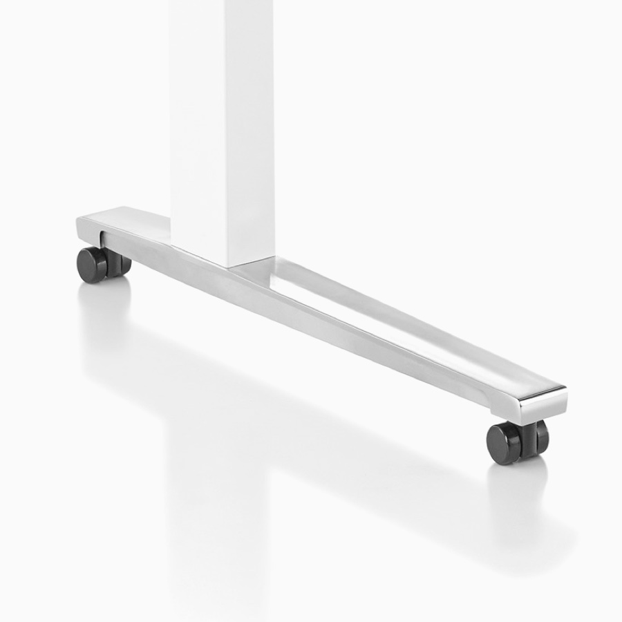 Close-up of Renew Sit-to-Stand Table's white C-leg base, polished aluminum feet with casters.