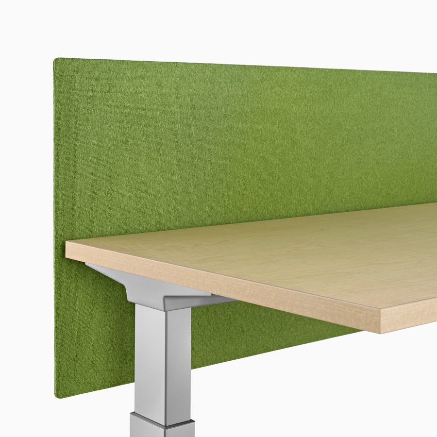 Close-up of a green fabric, Pari tapered edge, surface-attached privacy screen attached to a Renew Sit-to-Stand Table.