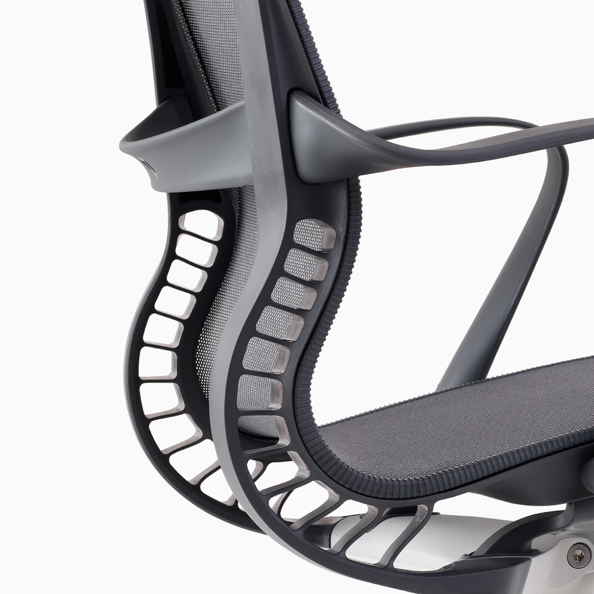 A close-up view of the Kinematic Spine on a grey Setu chair.