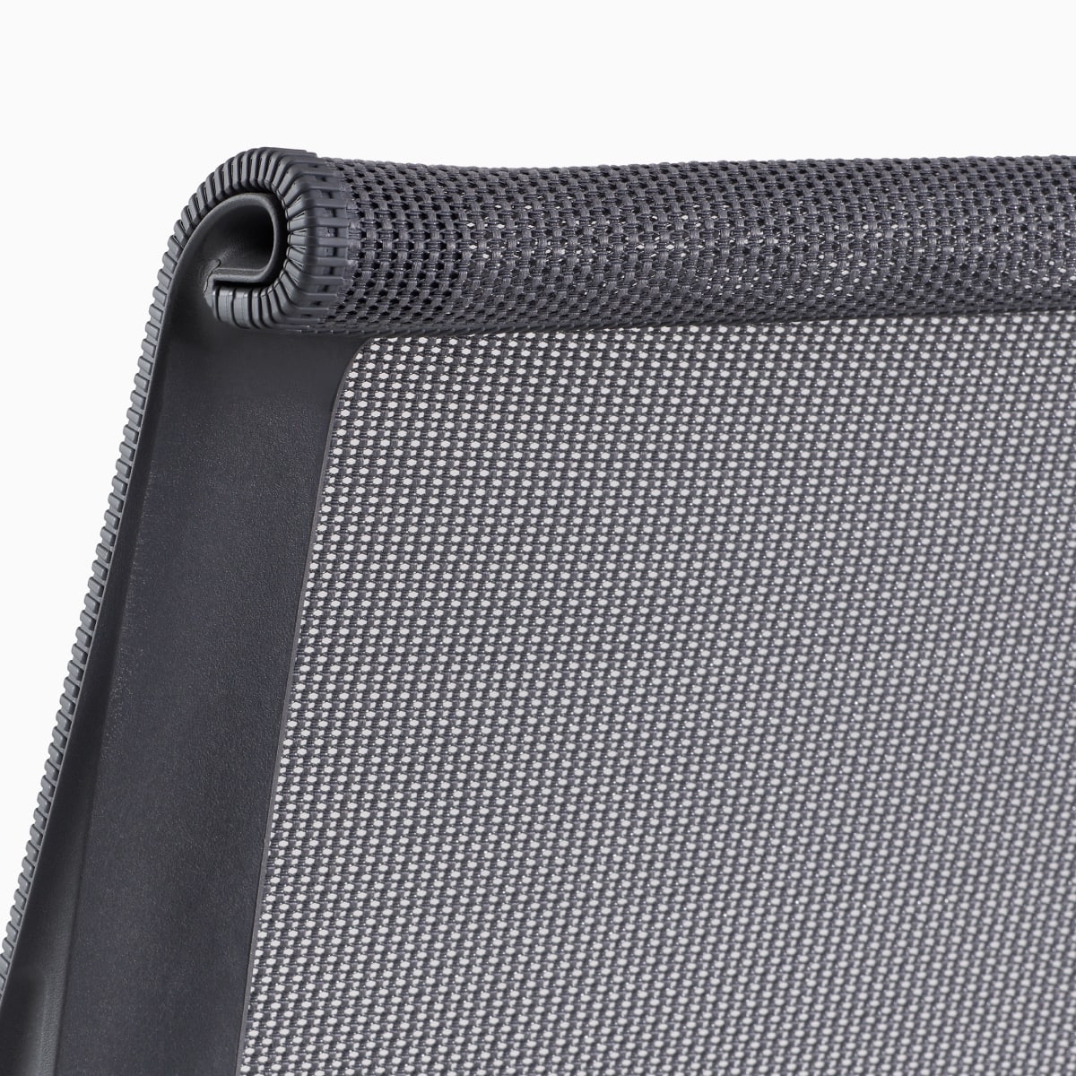 A close-up view of the suspension back of a Setu chair in grey.