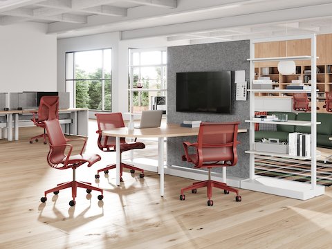 A workplace neighbourhood featuring red Setu Chairs and Stools, a variety of flexible workpoints, a focused space and a lounge area.