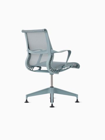 Rear-angle view of a Setu Side Chair with fixed arms in light blue.