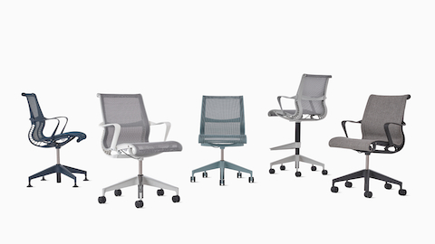 A group of five Setu chairs including a Setu Side Chair with arms in blue, a Setu Chair with white arms and grey suspension, an armless Setu Chair in light blue, a Setu stool in light grey and an upholstered Setu Chair with arms in grey.