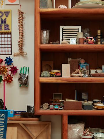 Tall shelves filled with small objects in Jesse Schlesinger's studio.