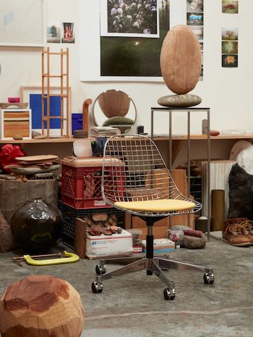 An Eames Wire Chair with yellow pad in Jesse Schlesinger's studio.