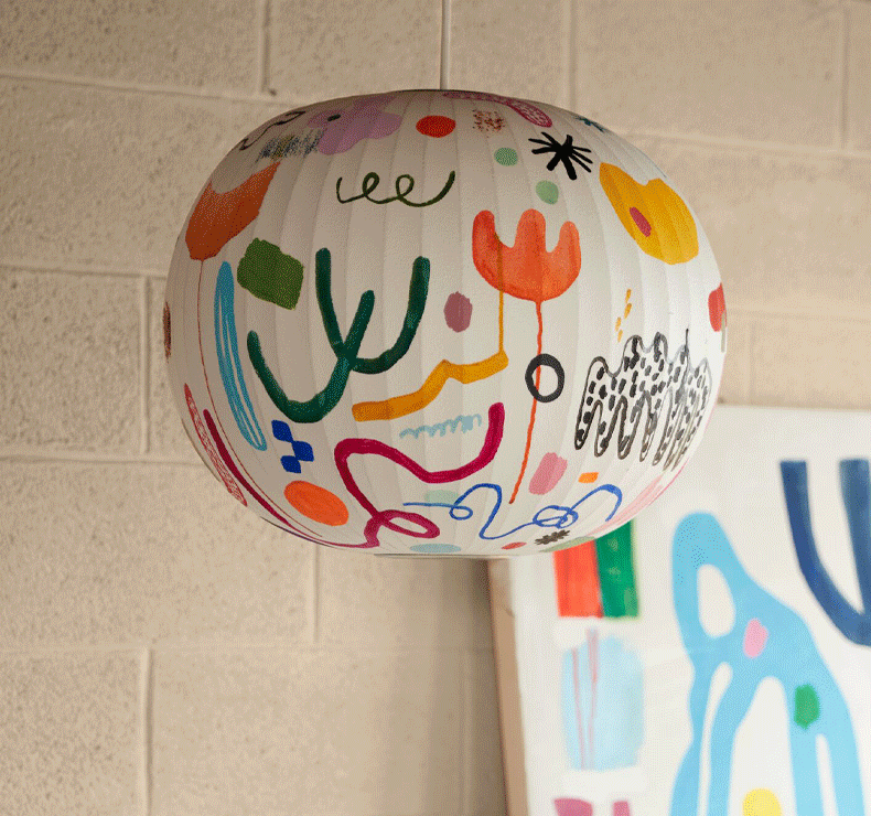 A Nelson Bubble Lamp, painted by Kindah Khalidy, flashing on and off.
